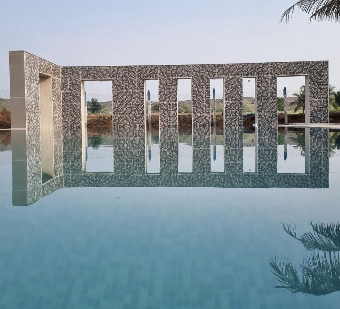 The pool wall mirrored in the water
