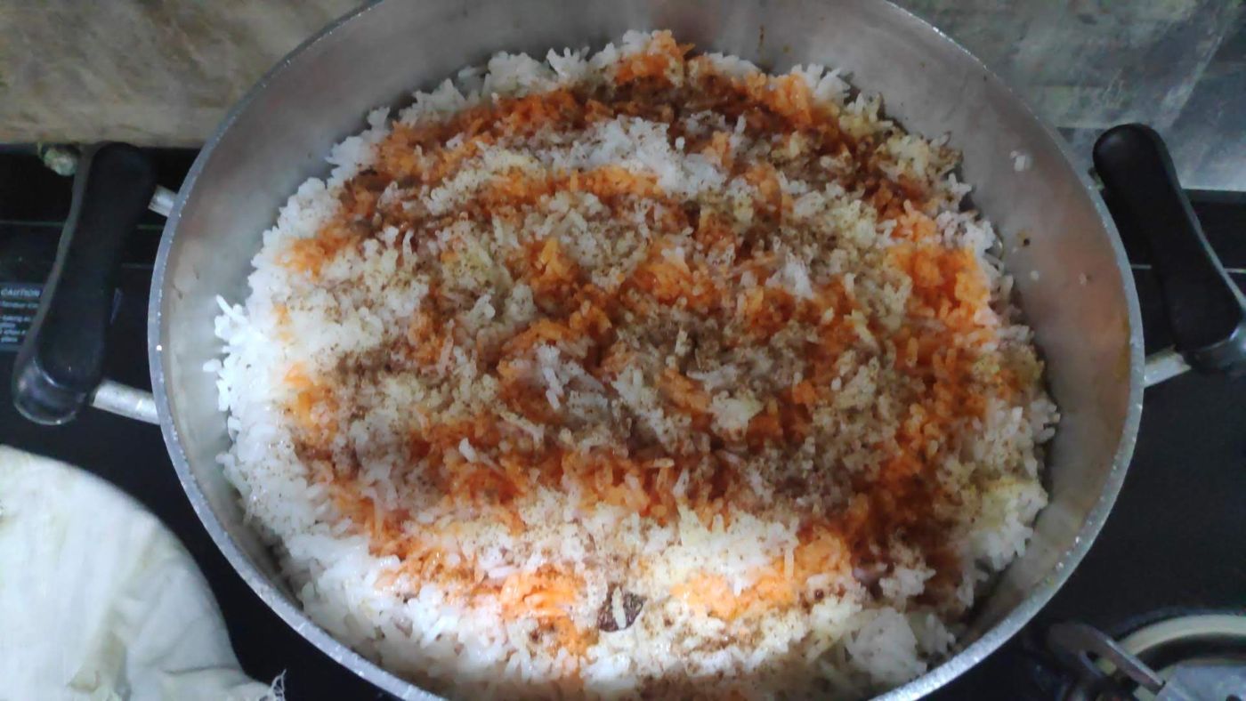 Biryani rice, layered and ready to steam