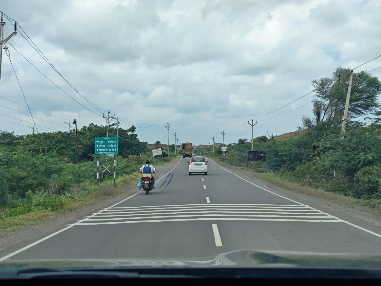 The open road through green countryside on the way to the farm